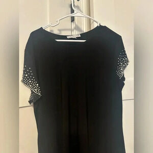 Little black dress with sleeve embellishments